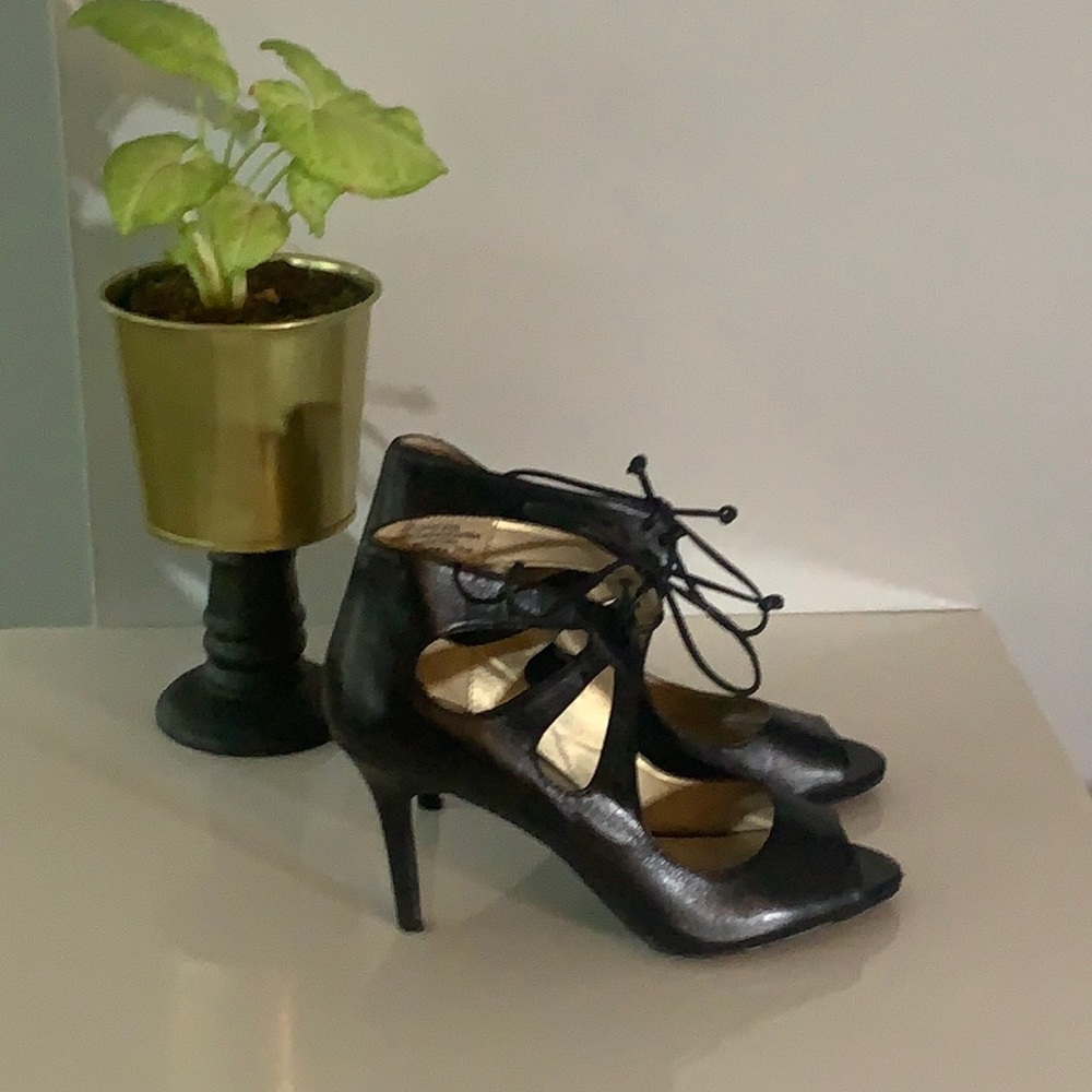 Black peep toe heel with lace accent. 7.5